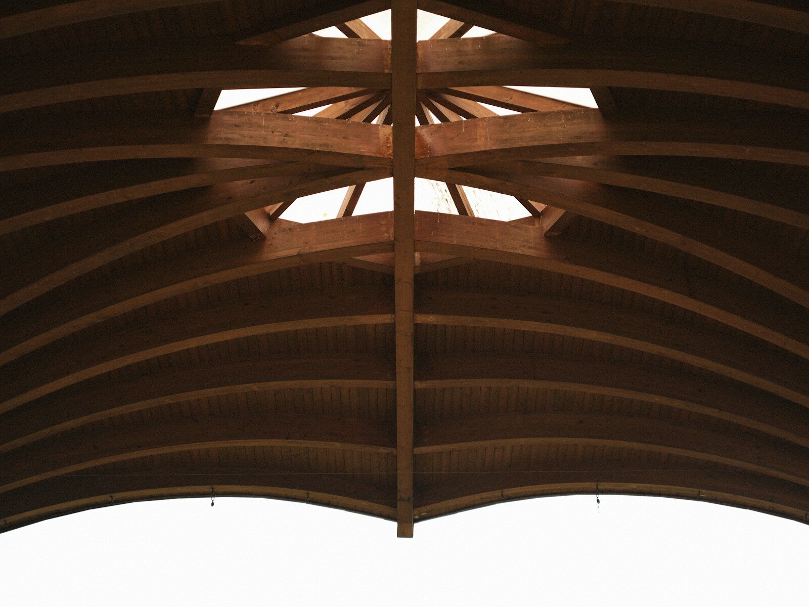 Wooden arched ceiling with a central skylight